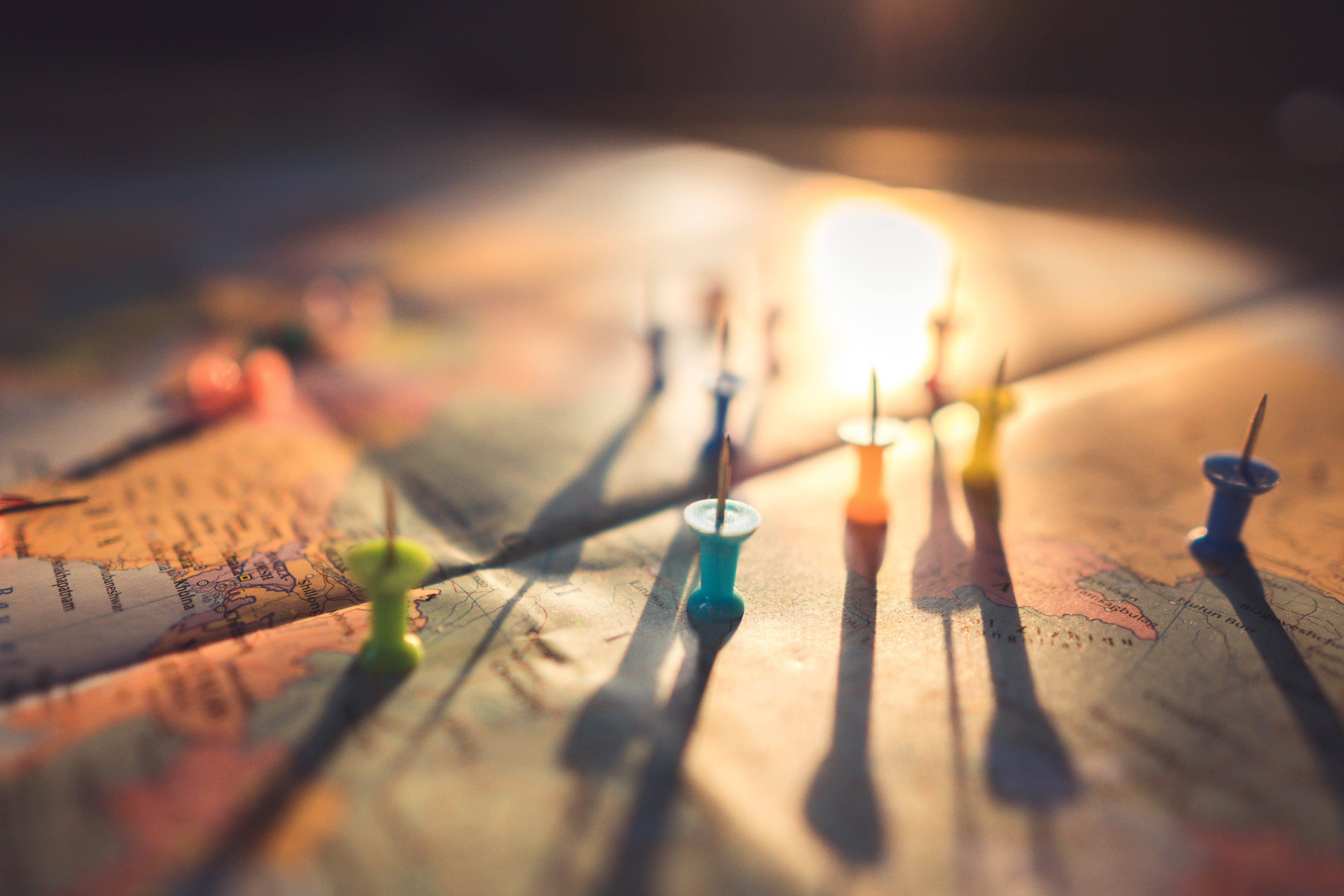 Photo of pins marking various spots on a world map