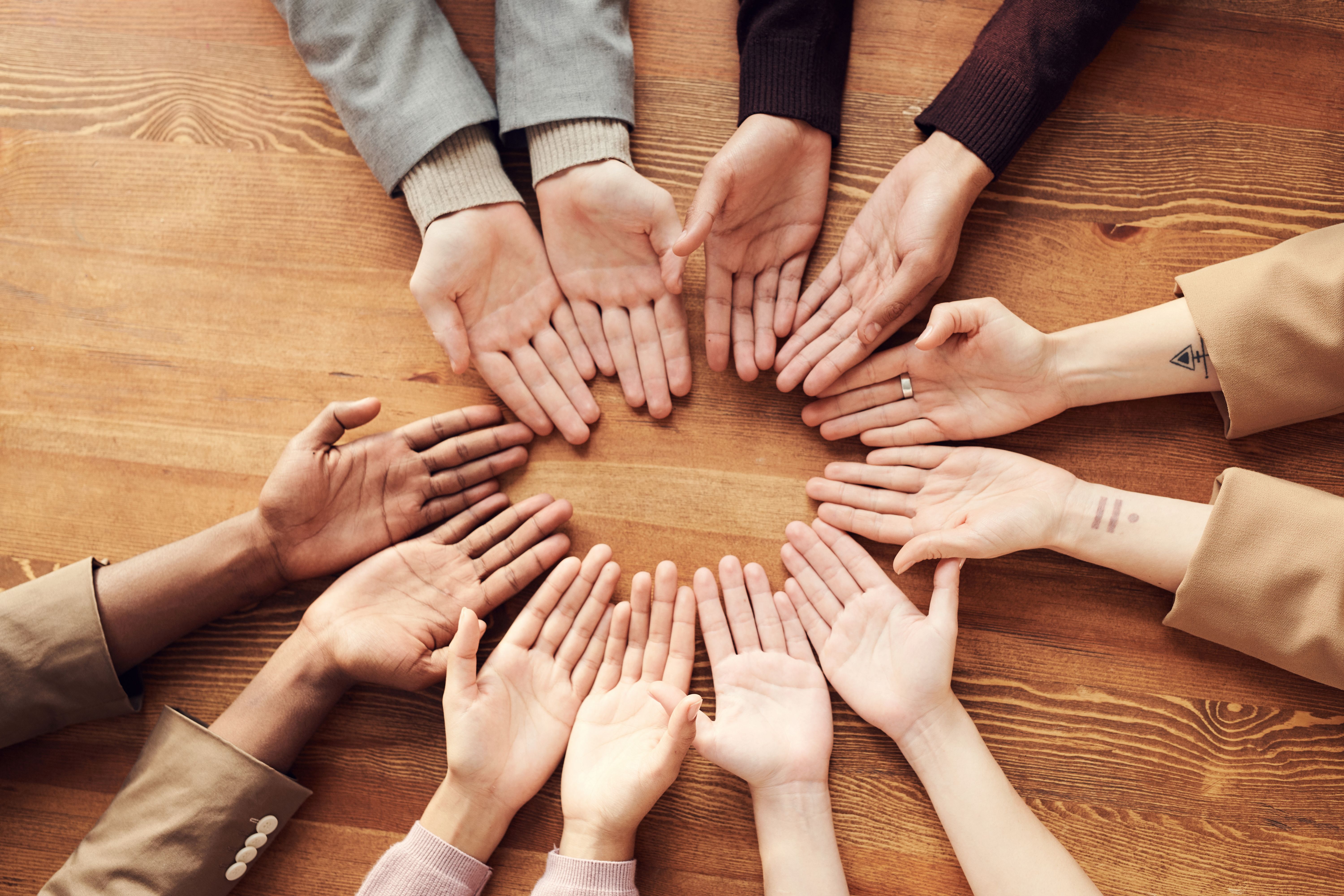 Photo of people touching hands